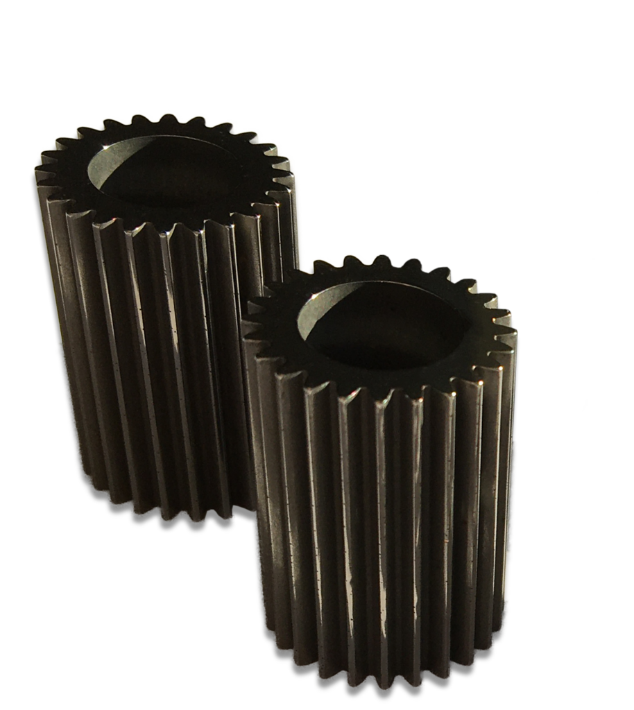 Two metal spur gears with straight, evenly spaced teeth are standing upright side by side on a white background. The gears are cylindrical and have hollow centers.
